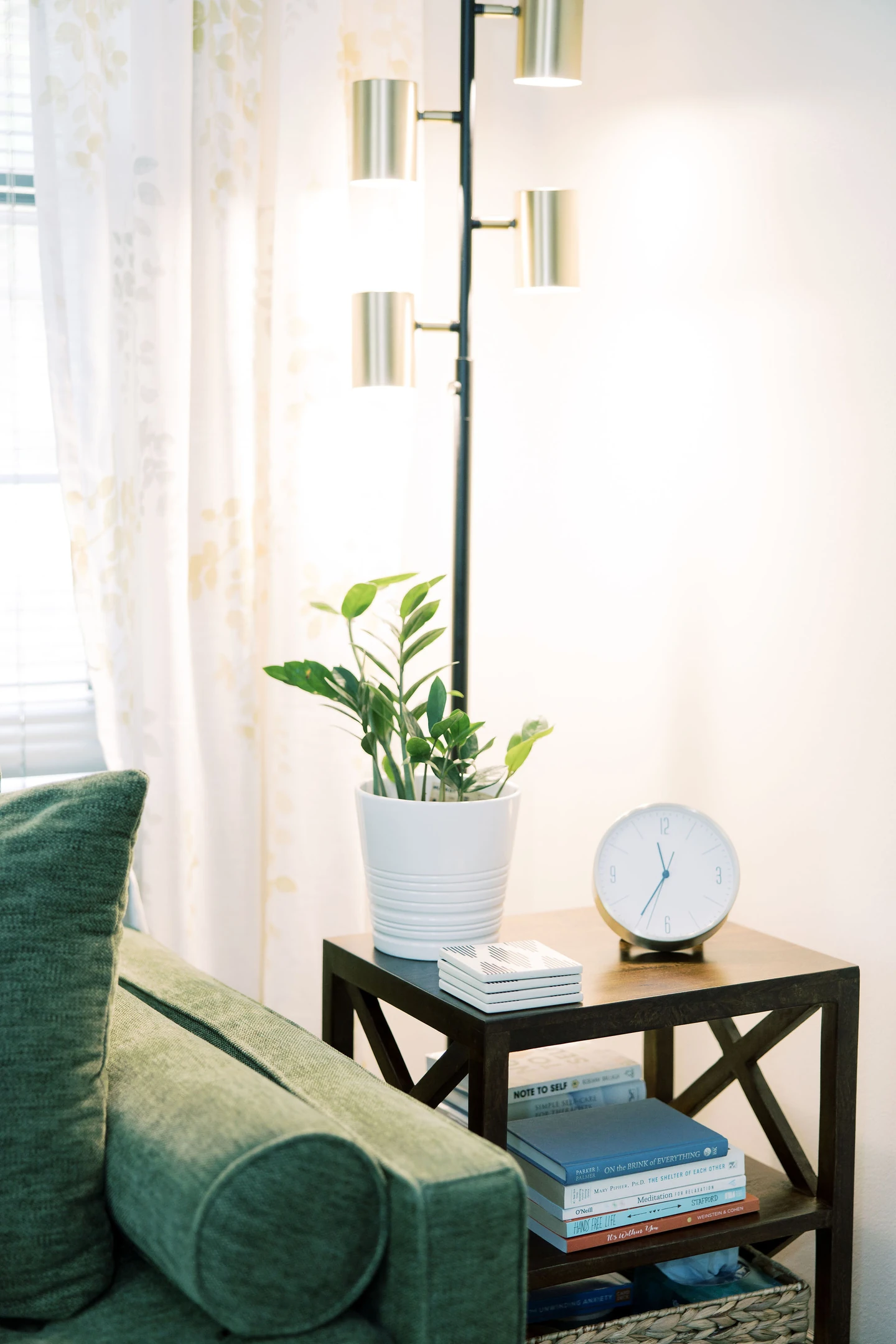Therapist's individual therapy office with plant, clock, light and couch